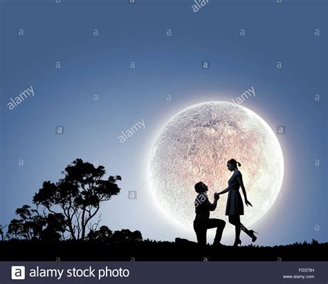 Silhouettes Of Romantic Couple Under The Moon Light Stock