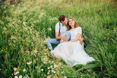 Happy Bride And Groom Walking On The Green Grass Stock Photo Image Of