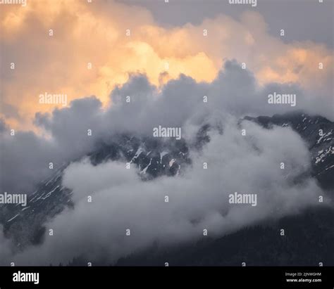 Dramatic Sky And Sunset Behind A Cloud Covered Mountain In The Bavarian