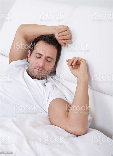 Portrait Of Young Man Sleeping On Bed Stock Photo Download Image Now