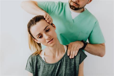 Professional Massage Therapist Releasing Tension In Female Patients