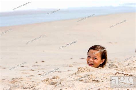 Girl Buried In Sand Stock Photo Picture And Low Budget Royalty Free