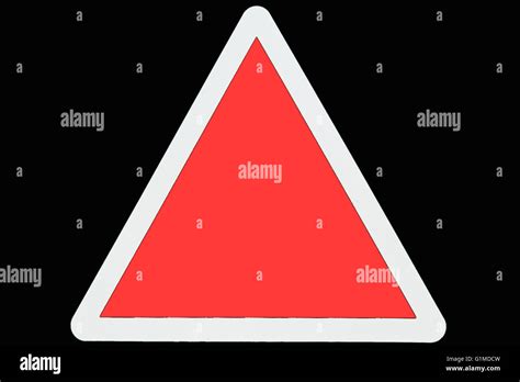 An Empty Red Triangle Road Warning Sign With A White Border Stock Photo