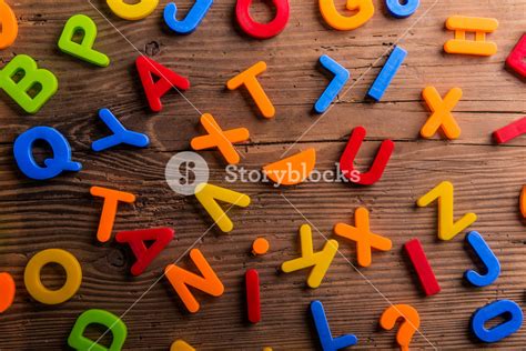 Colorful Plastic Letters And Numbers Laid On Wooden Background Royalty