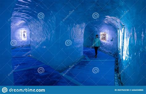 Female Tourist Walks Through The Breathtaking Blue Lit Gallery Inside