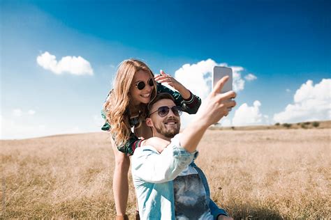 Couple Taking Selfie By Lumina Stocksy United