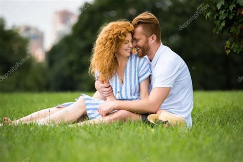 Smiling Redhead Couple Embracing Sitting Grass Park Stock Picture Ad Couple Embracing