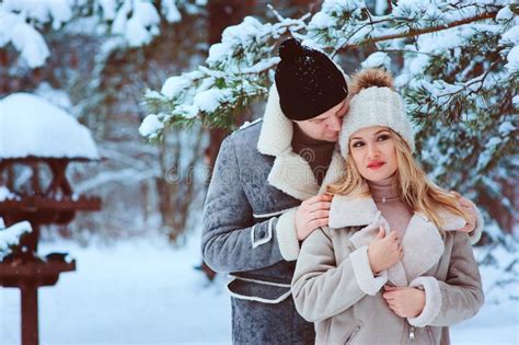 Winter Portrait Of Happy Romantic Couple Enjoying Their Walk In Snowy Forest Or Park Stock Image