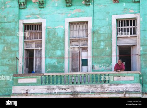 Daily Life In Cuba Cuban Man Leaning On Balcony At Havana Cuba West