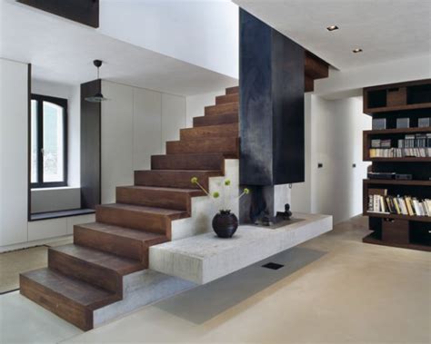 Striking modern entryway in white with clear glass stair railing. Contemporary Stairs