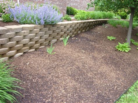 Flowers in house garden at brugges. Landscape Retaining Wall Options | Stone Work | Tri-Cities, WA