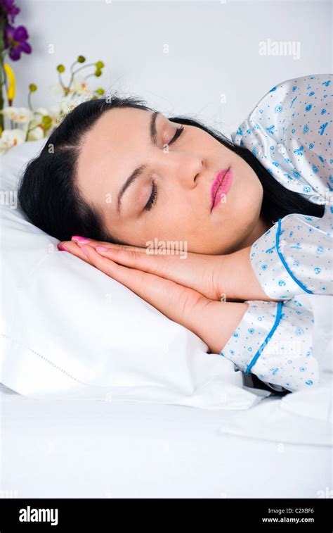 Close Up Of Beauty Woman Sleeping With Hands Under Face In Her Bed