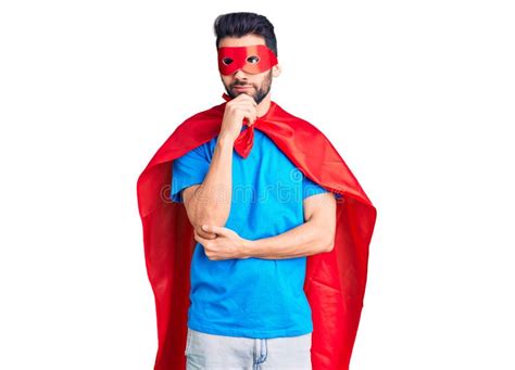 Young Handsome Man With Beard Wearing Super Hero Costume With Hand On