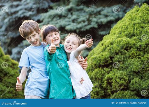 Group Of Happy Children Playing Outdoors Kids Having Fun In Summer
