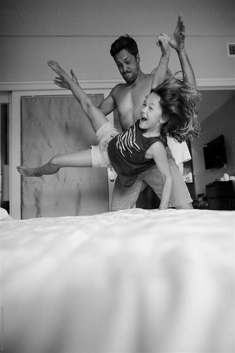 "Energetic Dad Playing With Kids In Hotel Room" by Stocksy Contributor