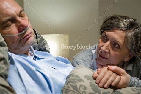 Anxious Old Woman Taking Care Of Sick Husband Royalty Free Stock Image