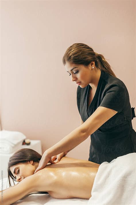 Woman Enjoying A Back Massage By Stocksy Contributor Victor Torres Stocksy