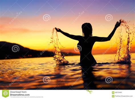 freedom,-enjoyment-woman-in-sea-at-sunset-happiness,-healthy-l-stock