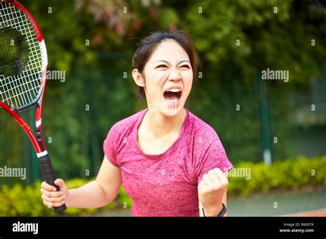 Young Asian Girl Female Tennis Player Celebrating After Scoring A Point