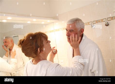 Senior Woman Applying Moisturizer On Her Husband Face Stock Photo Alamy
