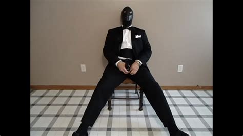 Seated In A Tuxedo Wearing A Rubber Cock And Ball Sheath And Playing With My Cock Until I Cum