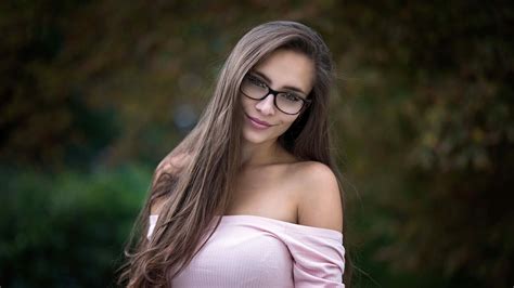 Long Hair Brunette Girl Model Is Wearing Glasses And Pink Dress In Blur