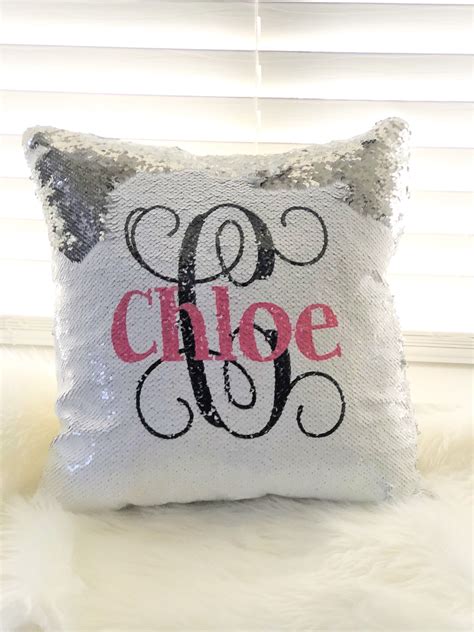 A Pillow With The Word Choose On It In Black And Silver Sequins Sitting
