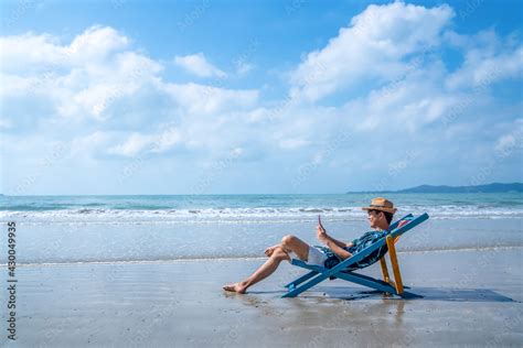 Asian Man Resting On Sunbed On Tropical Beach Happy Guy Sitting On
