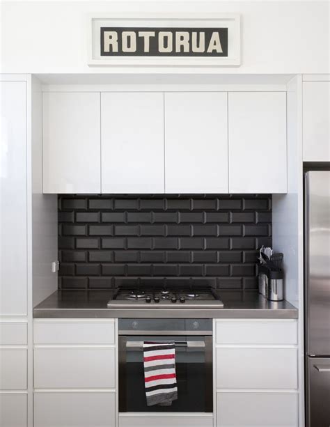 A backsplash of gray, black, and white oval mosaic tiles launched the design for this kitchen redo. square black kitchen splashback tiles - Google Search ...