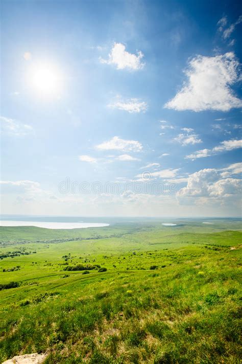 Photo Of Beautiful Landscape With Grassy Land Under Sunny Skies Stock