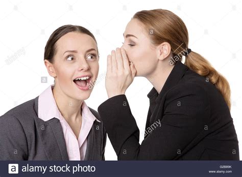 Close Up Shot Of Two Happy Pretty Business Women Sharing A Secret And