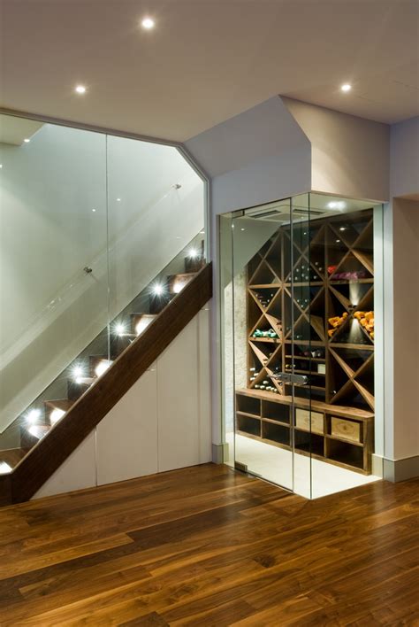 Drop ceiling window well slopes provide improved lighting. Splashy marvel wine cooler in Wine Cellar Contemporary ...