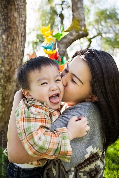 Asian Mother Kissing Her Happy And Cute Son By Suprijono Suharjoto