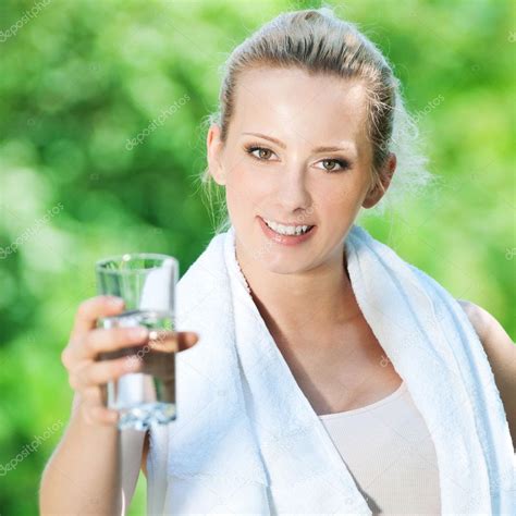 Woman Drinking Water After Exercise — Stock Photo © Markin 8461868