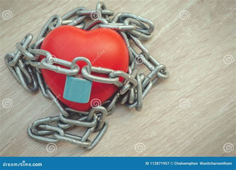 Padlock And Chain Locking A Red Heart On The Wooden Stock Image