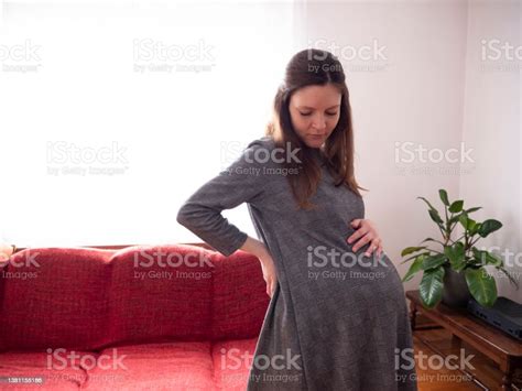 Beautiful Pregnant Woman Tries On Her New Pregnancy Dress At Home Stock