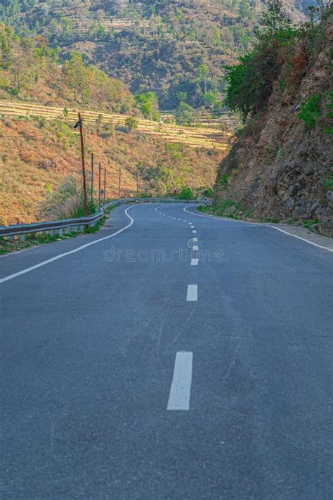 Mountain Curvy Road In Front Of Giant Green Mountain Stock Photo