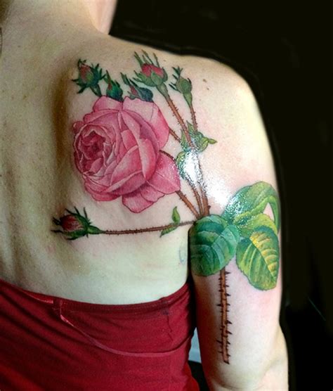The petals of the rose are inked a deep red while the leaves and stems are inked in black. 69 Graceful Roses Shoulder Tattoos