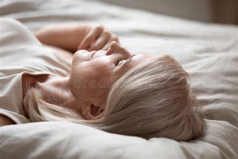 Tired Mature Woman Relax Sleeping In Comfy Bed Stock Photo Image Of