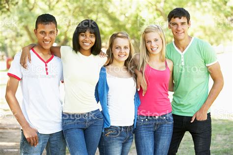Group Of Teenage Friends Standing In Park Stock Photo