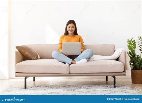 Happy Relaxed Chinese Woman Chilling At Home Using Laptop Stock Image