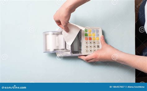Hands of a Young Woman Tearing a Check from the Cash Register after