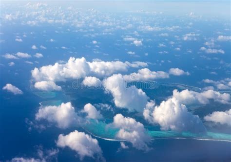 Polynesia The Atoll In Ocean Through Clouds Aerial View Stock Photo