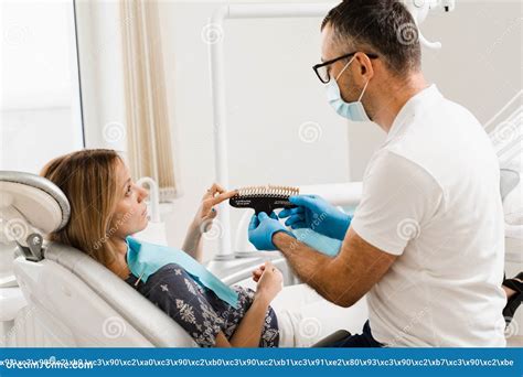 Consultation With Dentist About Teeth Whitening And Showing Girl