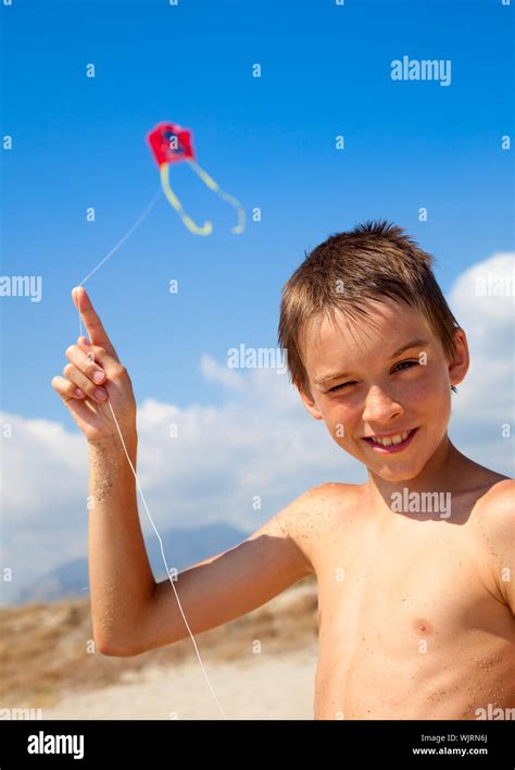 Boy Flying Kite On A Beach Stock Photo Alamy