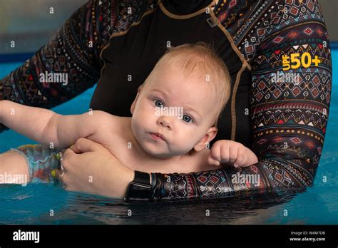 Infant Swimming Baby Girl Swimming In A Pool Stock Photo Alamy