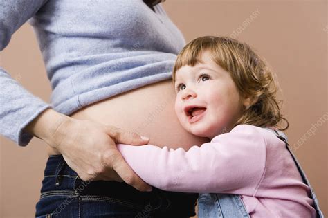 Girl Listening At Pregnant Mothers Belly Stock Image F003 2198 Science Photo Library