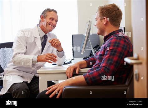 Patient Having Consultation With Male Doctor In Office Stock Photo Alamy
