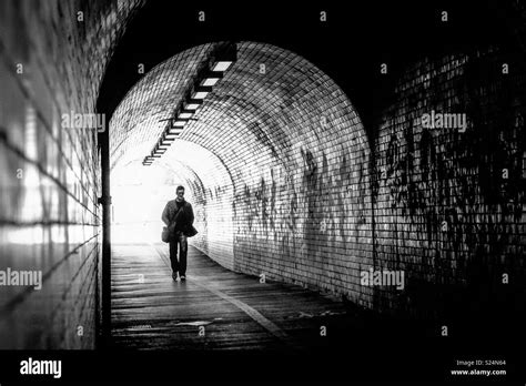 Man Walking Through A Tunnel Stock Photo Alamy