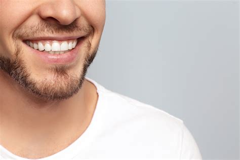 Young Man With Beautiful Smile On Grey Background Teeth Whiteni